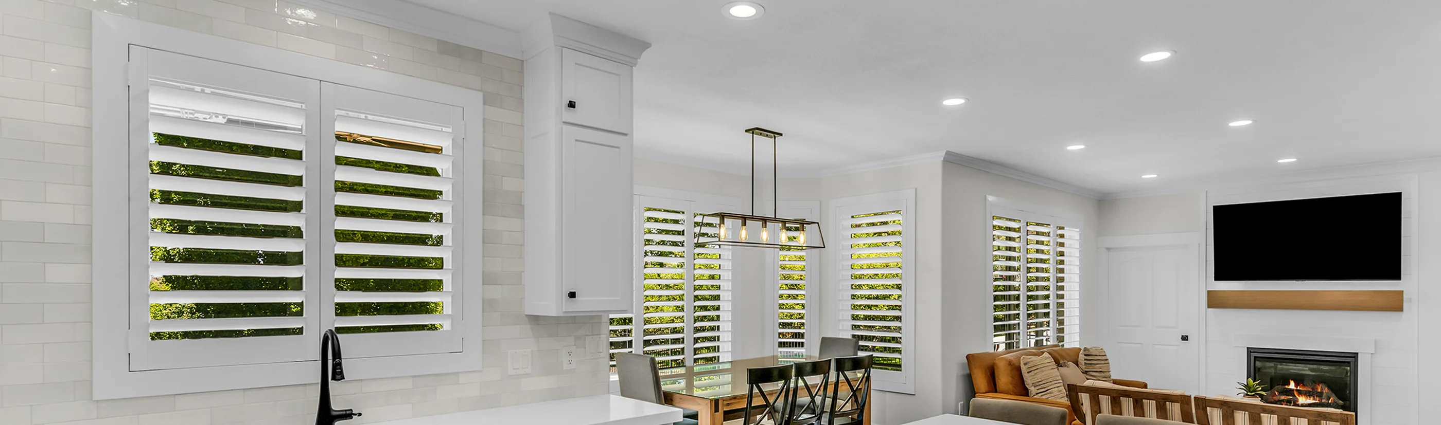 white polywood shutters in kitchen, breakfast nook and living room