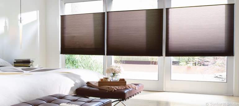 Contemporary Dallas bedroom with high ceiling windows and brown honeycomb shades.