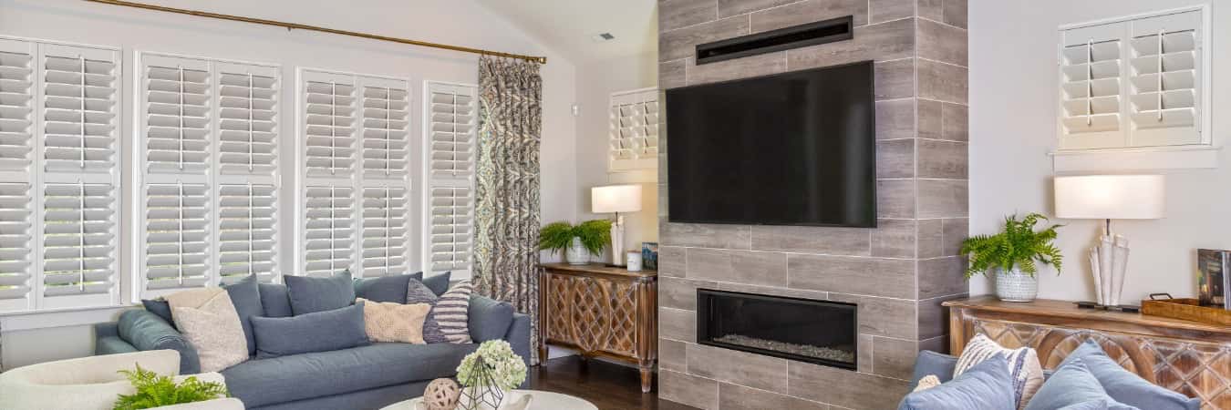 Interior shutters in Southlake family room with fireplace