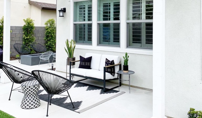 An outdoor with plantation window treatments