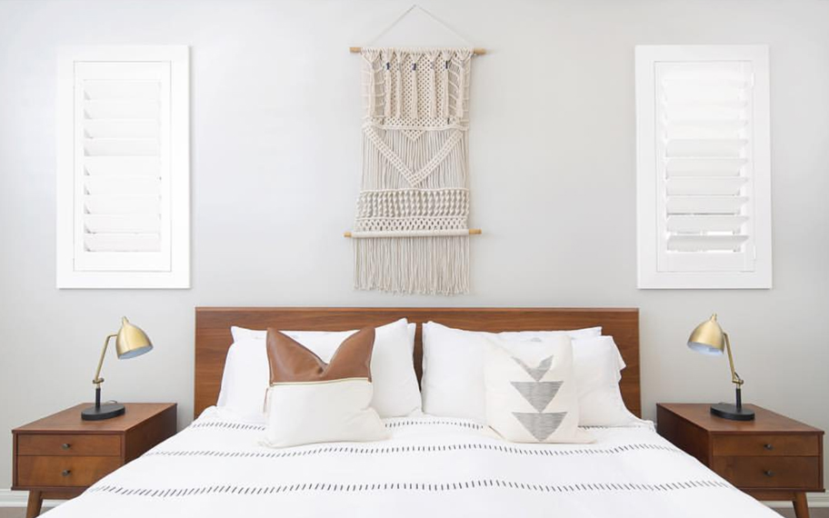 Custom-fitted louvered shutters provide excellent nighttime privacy in Dallas. Photo Credit: Audrey Crisp Louvered shutters in a bedroom.