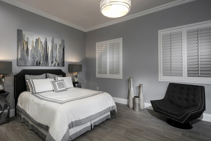 Close your custom Polywood shutters to beat the heat and keep your Dallas bedroom cool. White Polywood shutters on bedroom windows