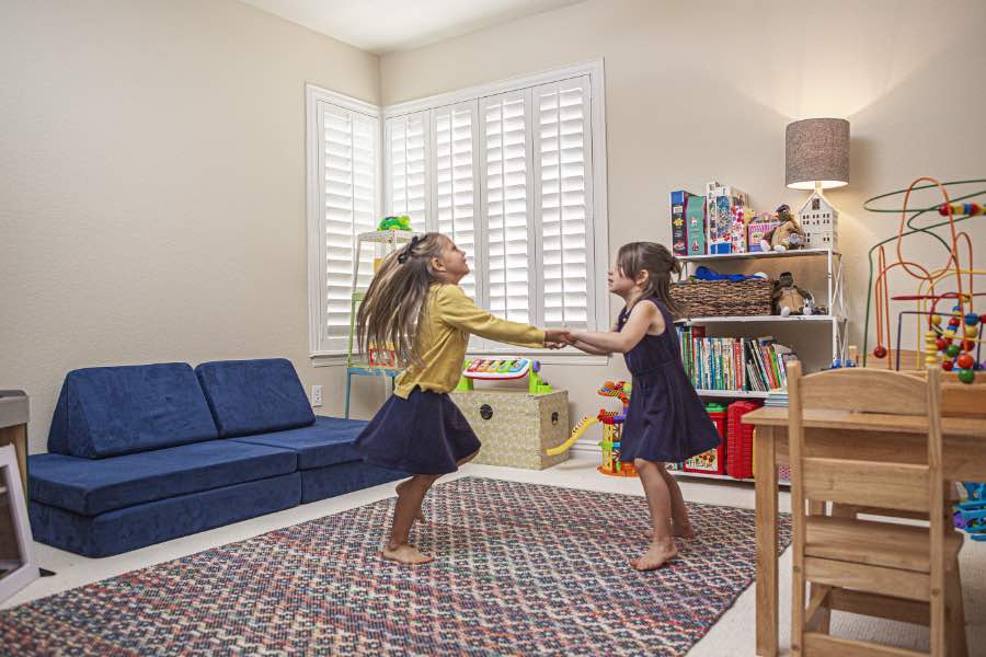 Choose Polywood shutters for durable, kid-friendly great room window treatments in Dallas. Polywood shutters on multiple windows in a sitting area