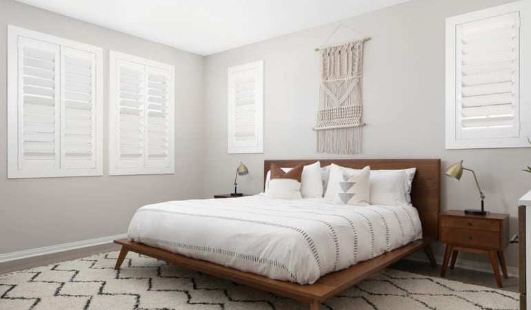 Open shutter louvers will help any Dallas room feel larger. Plantation shutters in a model home bedroom.