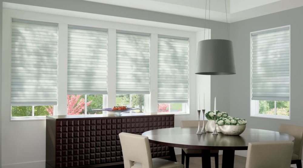 Custom cordless roller shades have a clean look and are appropriate for any room. Cordless motorized shades in a Dallas dining room