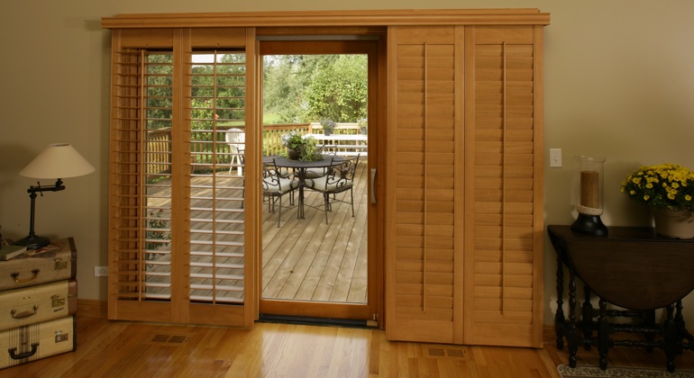 Wood shutters create a buffer that transitions from indoor wood to patio. Dallas wood shutter sliding door