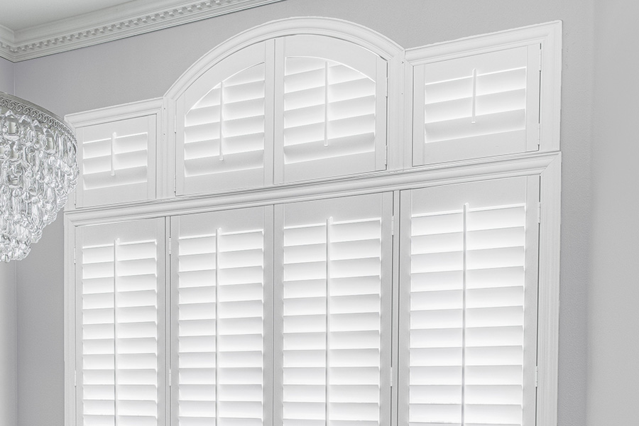 Customize your Palladian windows with white Polywood shutters in Dallas. White Polywood Palladian windows in a dining room.