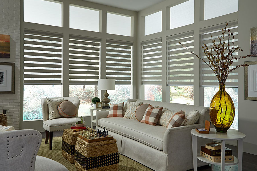Find window shades for every room of a house when you shop Sunburst's large selection. Gray transitional shades on a row of tall windows in a living room