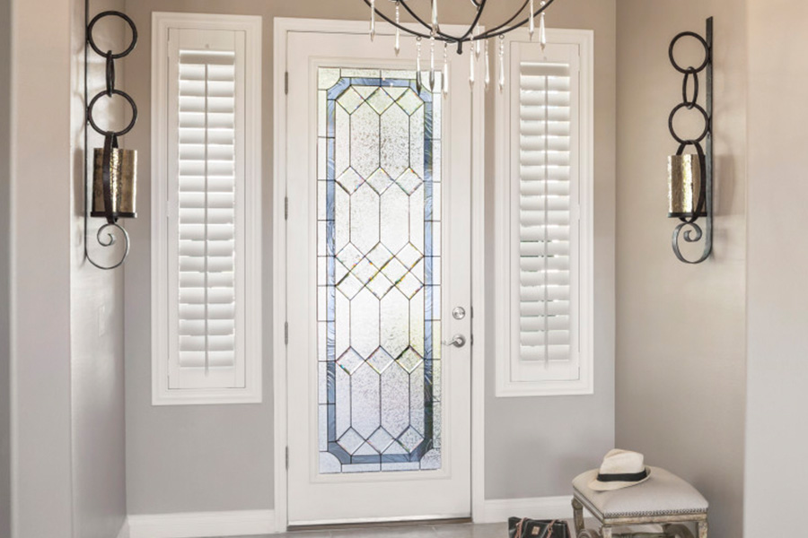 Polywood shutters offer flexibility on the brightness of natural light in Dallas. Sidelight windows with white polywood shutters in a foyer.