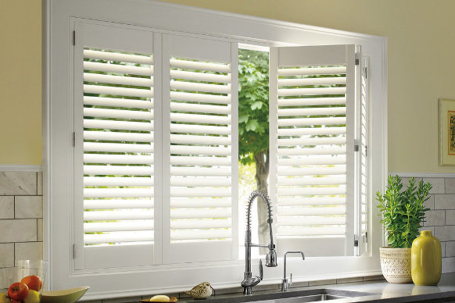 Polywood shutters are built to withstand the test of time in Dallas. White Polywood shutters above a kitchen sink.